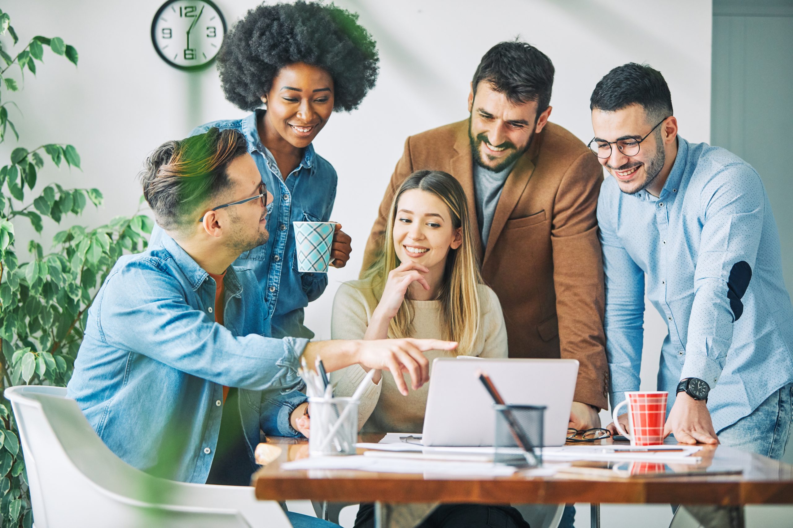 Group of young business people having a meeting in the office, having fun together and laughing,